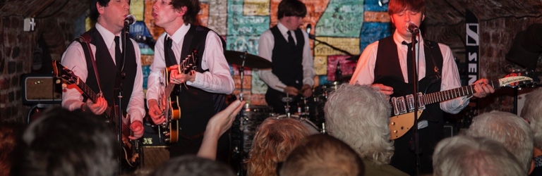 A tribute band playing in an underground nightclub.