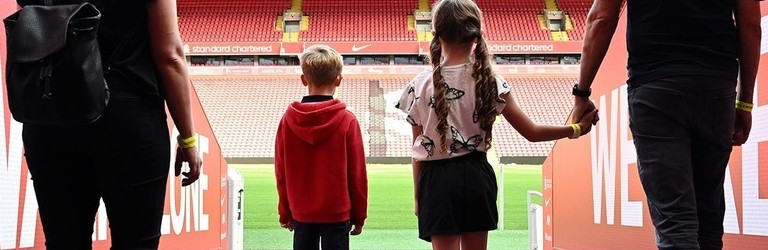 A family walking through the Tunnel to view the pitch as part of the stadium tour.