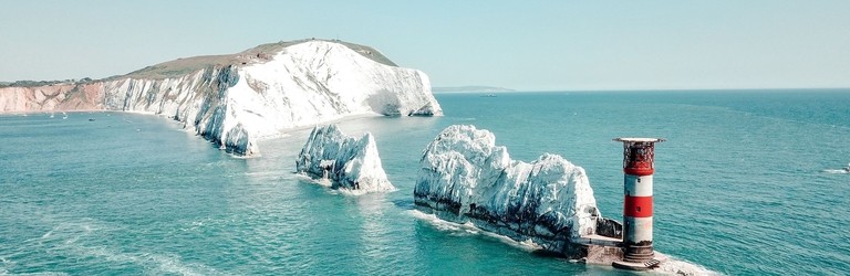 Aerial view of white rock formations standing tall from sea
