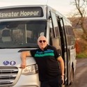 Bus driver standing in front of bus