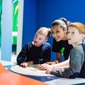 Two boys playing with interactive display in a museum