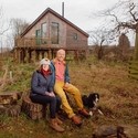 owners sitting in front of cottage