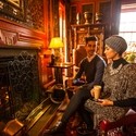A young Arab couple relaxing by a fire in the drawing room