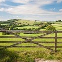 A five bar gate with countryside views across fields