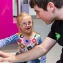 Young girl with Downs Syndrome feeling textures on a board