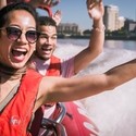 Close up of man young woman and man riding on speed boat on the Thames