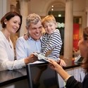 Family buying entry tickets from a museum reception