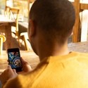 Male business owner looking at restaurant menu on smart phone