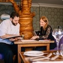 Head Chef and female nutritionalist sat in empty restaurant discussing menu plans for The Green House Hotel, Bournemouth