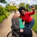 Two women taking a selfie, Helmsley Castle in the background