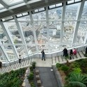 People walking down the stairs Sky Garden wth the city in the background