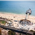Aerial view of Bournemouth Pier looking out to sea with beach full of people