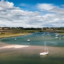 Sailboats moored on the Aln River at the edge of the North Sea at Alnmouth, Northumberland Coast Path.