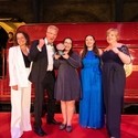 Photo of Gold Award Winners for the Accessible & Inclusive Tourism Award at the VisitEngland Awards for Excellence 2023 - Noah's Ark Zoo Farm (Representatives from Noah's Ark Zoo Farm, VisitEngland Director of HR and Professional Services Debra Lang, Relationship Director for Hospitality & Leisure at Corporate Banking Barclays Andy Mayne, Compere Alex Polizzi) - in front of the Hogwarts Express on stage