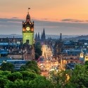 Balmoral's clock tower with Edinburgh cityscape skyline and Scott Monument background during sunset