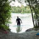 Woman in a wetsuit walking through water