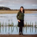 Lucy Downing standing near a lake